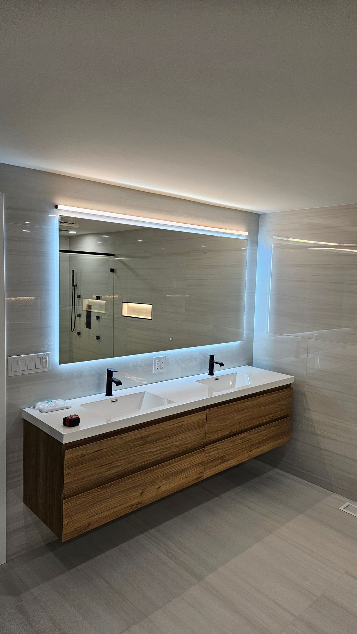 Floating vanity with a backlit mirror